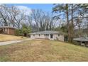 A quaint ranch home featuring a well-kept lawn and a welcoming front facade at 2328 Starline Dr, Decatur, GA 30032