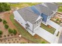 Aerial view of a new construction home featuring manicured lawn, landscaping, and a concrete driveway at 1985 William Glen St, Dacula, GA 30019
