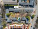 Aerial view showcasing the townhome community, pool, parking, landscaping, and proximity to the street at 3535 Roswell Ne Rd # H2, Atlanta, GA 30305