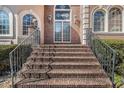 A stately brick entrance staircase leading to a home with arched windows and glass front doors at 461 Wynns Way, Atlanta, GA 30331