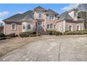 Elegant brick home featuring arched windows, stately entrance, and manicured landscaping at 461 Wynns Way, Atlanta, GA 30331