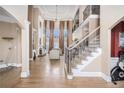 Spacious living room with two-story ceilings, fireplace, hardwood floors and elegant staircase at 461 Wynns Way, Atlanta, GA 30331
