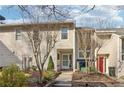 Attractive townhome featuring well-maintained landscaping, a concrete walkway, and a pleasing color scheme at 1908 Variations Ne Dr, Atlanta, GA 30329