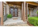 Close-up of impressive double front doors with brick entryway, pillars, and manicured bushes at 2353 Habersham Sw Dr, Marietta, GA 30064