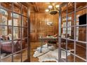 Sophisticated home office featuring wood paneling, coffered ceiling, and a cowhide rug at 2353 Habersham Sw Dr, Marietta, GA 30064