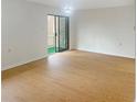 Bright, airy living room with sleek floors, neutral walls, and a sliding glass door to a balcony at 475 Mount Vernon Ne Hwy # C230, Sandy Springs, GA 30328