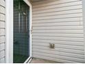 Exterior view of a home entrance showcasing the screen door and light-colored siding at 158 Oak Grove Pl, Acworth, GA 30102