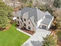Stunning exterior view of a traditional brick home with a lush green lawn and well-manicured landscaping at 4895 Lansbury Dr, Atlanta, GA 30342