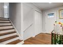 Bright entryway featuring hardwood floors, white trim, closet, and stairs to the second level at 2837 Marlin Dr, Chamblee, GA 30341