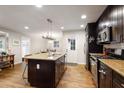 Modern kitchen featuring a center island with granite countertop, stainless steel appliances, and hardwood floors at 2837 Marlin Dr, Chamblee, GA 30341