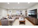 Comfortable living room with ample lighting, hardwood floors, and a large sectional sofa at 2837 Marlin Dr, Chamblee, GA 30341