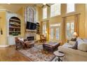 Inviting living room with soaring ceilings, stone fireplace, custom built-ins, and French doors at 4175 Onslow Se Pl, Smyrna, GA 30080