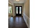 Elegant entryway with hardwood floors and a glass-paneled front door at 7260 Bluewater Ln, Douglasville, GA 30135