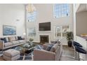Cozy living room with a fireplace, stylish furniture, and a bright window view at 114 Highgrove Pl, Mcdonough, GA 30253