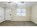 Bright living room featuring neutral carpet, a ceiling fan, a window, and a white front door for a clean, inviting space at 6120 Gwendoline Dr, Atlanta, GA 30349