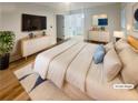 Bright main bedroom with natural light, wood flooring, and ensuite bathroom at 4409 Idlewood Ln, Tucker, GA 30084