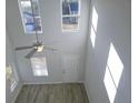 Bright living room with a ceiling fan and large windows letting in natural light at 15 Barton Lane, Covington, GA 30016