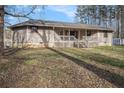 Back exterior of home with a wooden deck and stairs, surrounded by a spacious yard at 931 Highway 92 N, Fayetteville, GA 30214