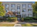 Beautiful facade showcasing a classic condo building with brick accents and lush greenery at 3 Park Ne Ln # H, Atlanta, GA 30309