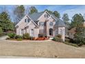 Stunning two-story brick home showcasing a manicured front lawn and lush landscaping in a desirable neighborhood at 3835 Greenside Ct, Dacula, GA 30019