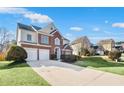 Beautiful two-story home featuring a well-kept lawn, two-car garage, and classic brick accents at 5466 Vinings Lake Way, Mableton, GA 30126