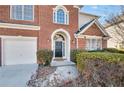 Close-up of the front door framed by brick, with an attached two-car garage at 5466 Vinings Lake Way, Mableton, GA 30126