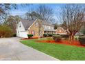 Well-manicured lawn and landscaping lead to this charming two-story home with attached two-car garage at 3242 Inns Brook Way, Snellville, GA 30039