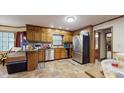 Spacious kitchen featuring stainless steel appliances, tile floors, and a breakfast bar at 3242 Inns Brook Way, Snellville, GA 30039