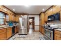 Well-lit kitchen with stainless steel appliances, ample cabinet space, and neutral tile flooring at 3242 Inns Brook Way, Snellville, GA 30039