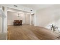 Dining area featuring a chandelier, hardwood floors, and an open doorway to another room at 77 Peachtree Ne Pl # 402, Atlanta, GA 30309