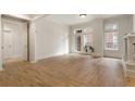 Bright living room with hardwood floors, with large windows leading to a small balcony at 77 Peachtree Ne Pl # 402, Atlanta, GA 30309