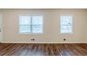 Spacious living room featuring two windows and hardwood flooring providing ample natural light at 2504 Brentwood Rd, Decatur, GA 30032