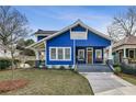 Beautiful blue two-story home with a cozy front porch and manicured lawn at 726 Brookline Sw St, Atlanta, GA 30310