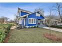 Side view of a blue two-story home with a welcoming front porch and green lawn at 726 Brookline Sw St, Atlanta, GA 30310