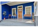 Inviting front porch featuring a wooden door and comfortable seating area at 726 Brookline Sw St, Atlanta, GA 30310
