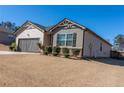 Single-Gathering home with gray garage door, well-maintained lawn, and dark shutters at 8125 Berrywood Se Ct, Covington, GA 30014