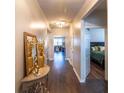 Hallway with decorative table, mirror, and view into the living room and bedroom at 8125 Berrywood Se Ct, Covington, GA 30014