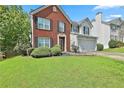 Traditional two-story house with brick and siding, green lawn, and attractive landscaping at 2726 Northgate Nw Way, Acworth, GA 30101