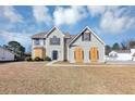 Exterior view of a two-story home with gray siding, shutters, and lawn at 3060 White Oak Mews, Decatur, GA 30034