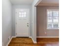 Entryway featuring hardwood floors, a white front door, and a window providing natural light at 3368 Windsor Castle Ct, Decatur, GA 30034