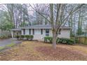 Single story home with brick facade, black shutters and mature tree in front yard at 2024 Rosewood Rd, Decatur, GA 30032