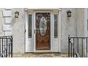 A closer view of a wooden front door with decorative glass inserts and sidelights at 3938 Belle Glade Ct, Snellville, GA 30039