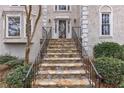 Close-up of the stone stairs leading to the front door with decorative glass and iron railings at 3938 Belle Glade Ct, Snellville, GA 30039