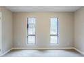Bedroom with neutral paint, carpet flooring, and bright windows offering natural light at 3998 Chimney Ridge Dr, Ellenwood, GA 30294