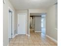Hallway with neutral paint and tile floor leading to different parts of the house at 3998 Chimney Ridge Dr, Ellenwood, GA 30294