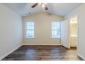 Bedroom featuring wood floor, windows for natural light, and an ensuite bathroom at 2464 Hampshire Cv, Conyers, GA 30013