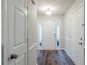 Bright entryway featuring a white front door with sidelights and paneled doors at 2464 Hampshire Cv, Conyers, GA 30013