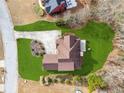 An aerial view shows the home's roof, pristine lawn, and backyard landscaping at 3207 Haleys Way, Conyers, GA 30013