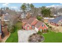 Charming brick home with a manicured lawn, circular driveway, and mature landscaping at 3207 Haleys Way, Conyers, GA 30013