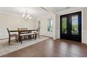 Formal dining room featuring hardwood floors, decorative molding, and a stylish light fixture at 8023 White Stone Blvd, Douglasville, GA 30135